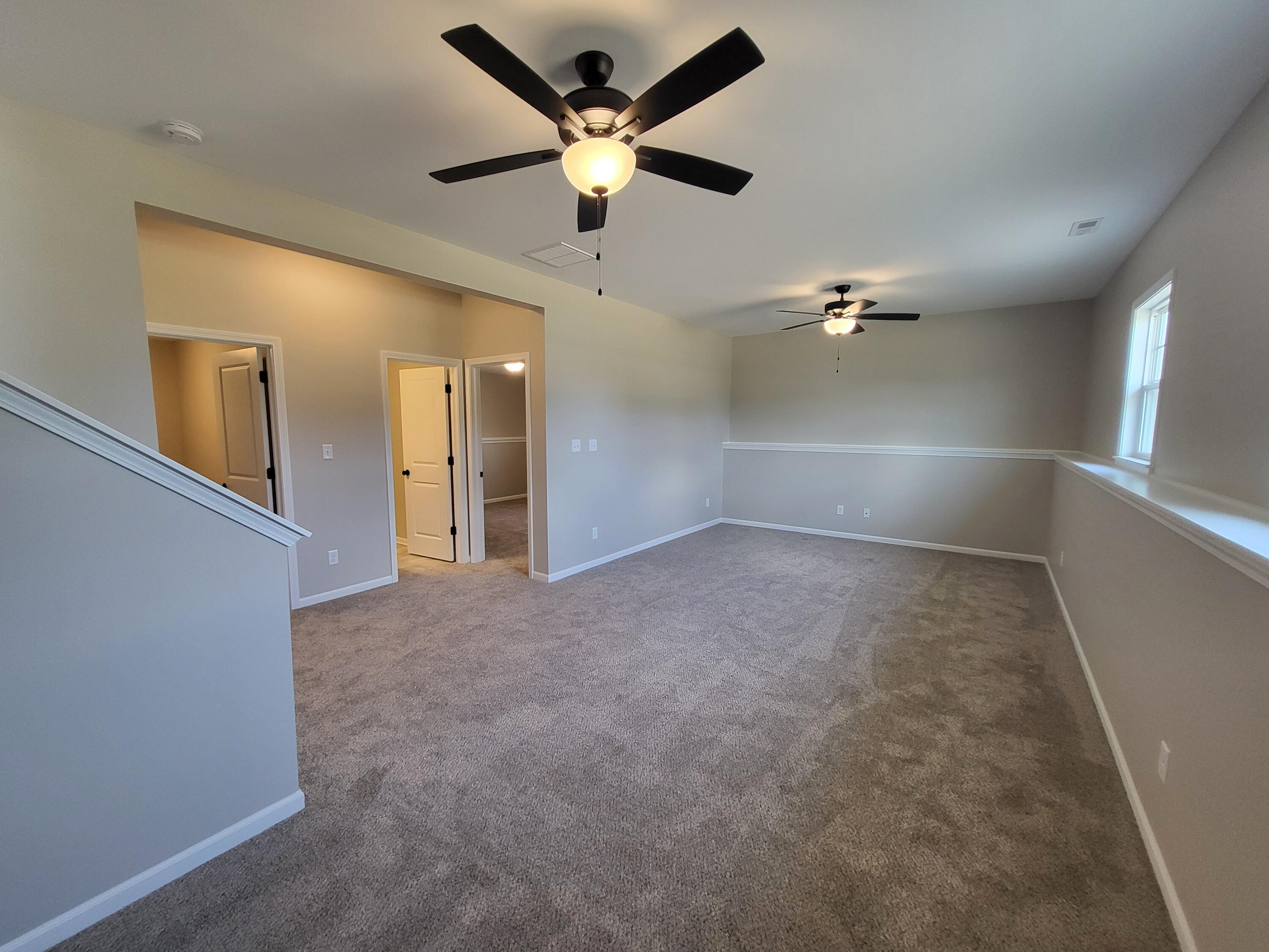 18425 Alexander Avenue Lowell, IN 46356 - Photo 16 of 34 en empty room with ceiling fan and window