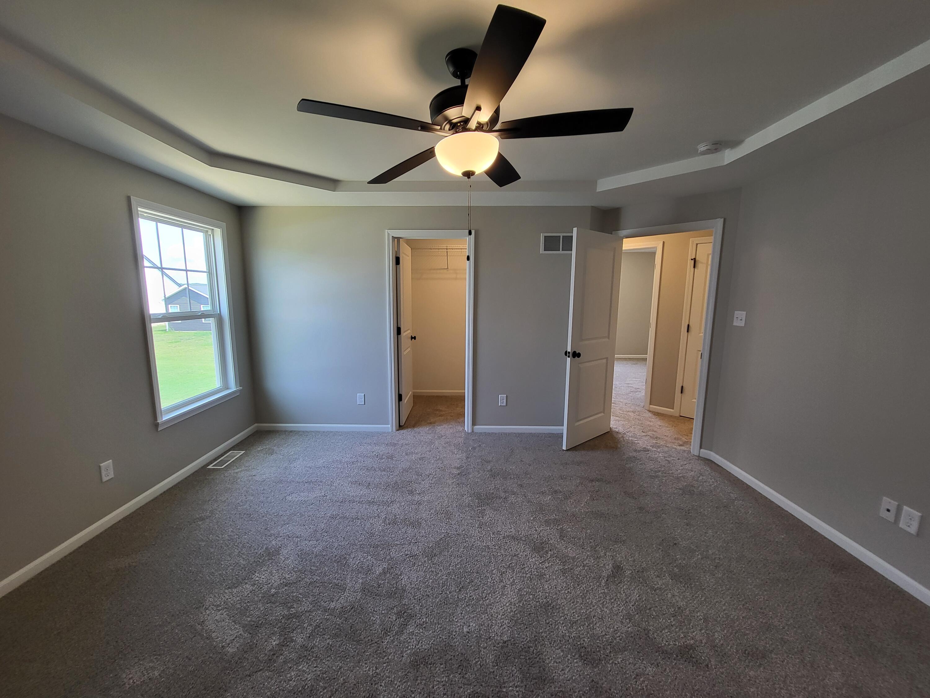 18425 Alexander Avenue Lowell, IN 46356 - Photo 19 of 34 an empty room with ceiling fan and windows
