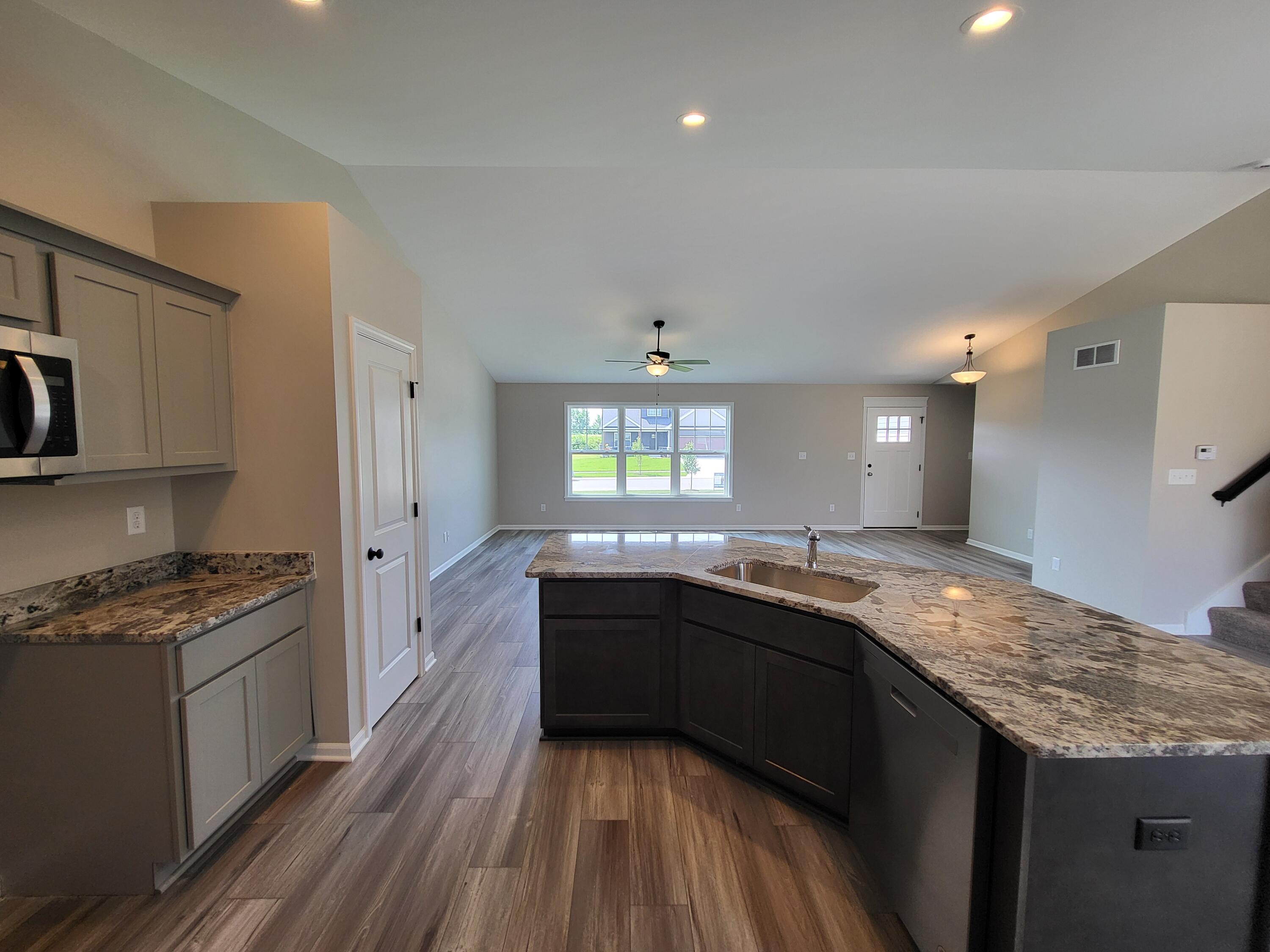 18425 Alexander Avenue Lowell, IN 46356 - Photo 2 of 34 a kitchen with granite countertop stainless steel appliances and wooden cabinets