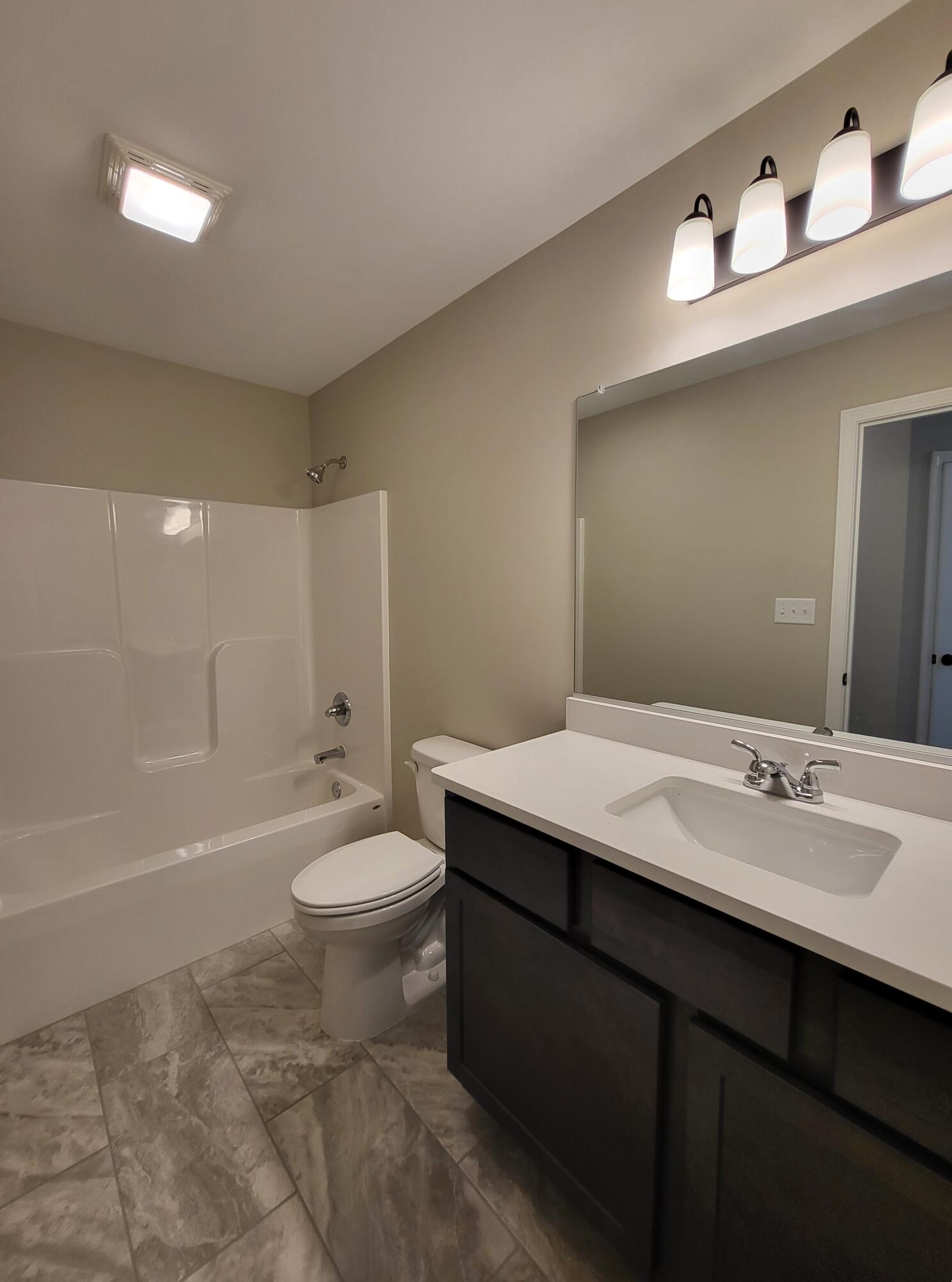 18425 Alexander Avenue Lowell, IN 46356 - Photo 24 of 34 a bathroom with a sink a toilet and shower