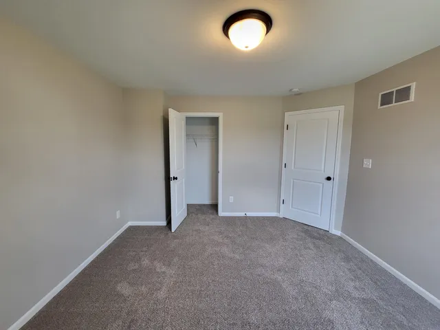 an empty room with a empty space and windows