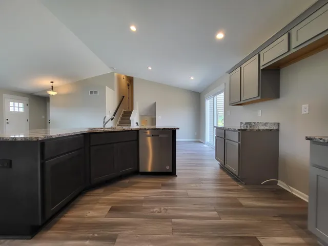 a kitchen with stainless steel appliances granite countertop a stove and a sink