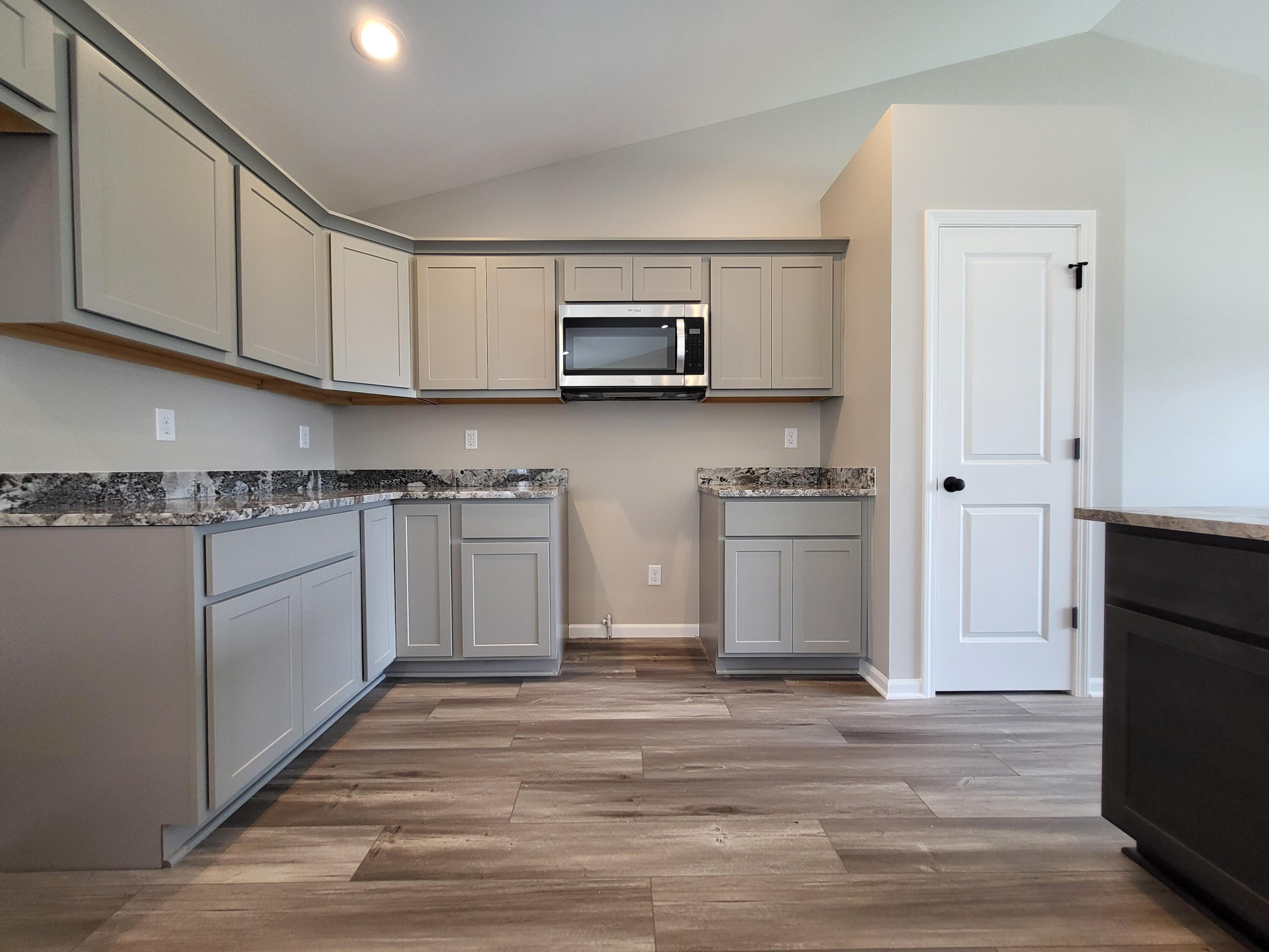 18425 Alexander Avenue Lowell, IN 46356 - Photo 6 of 34 a kitchen with stainless steel appliances granite countertop a stove a sink and a microwave