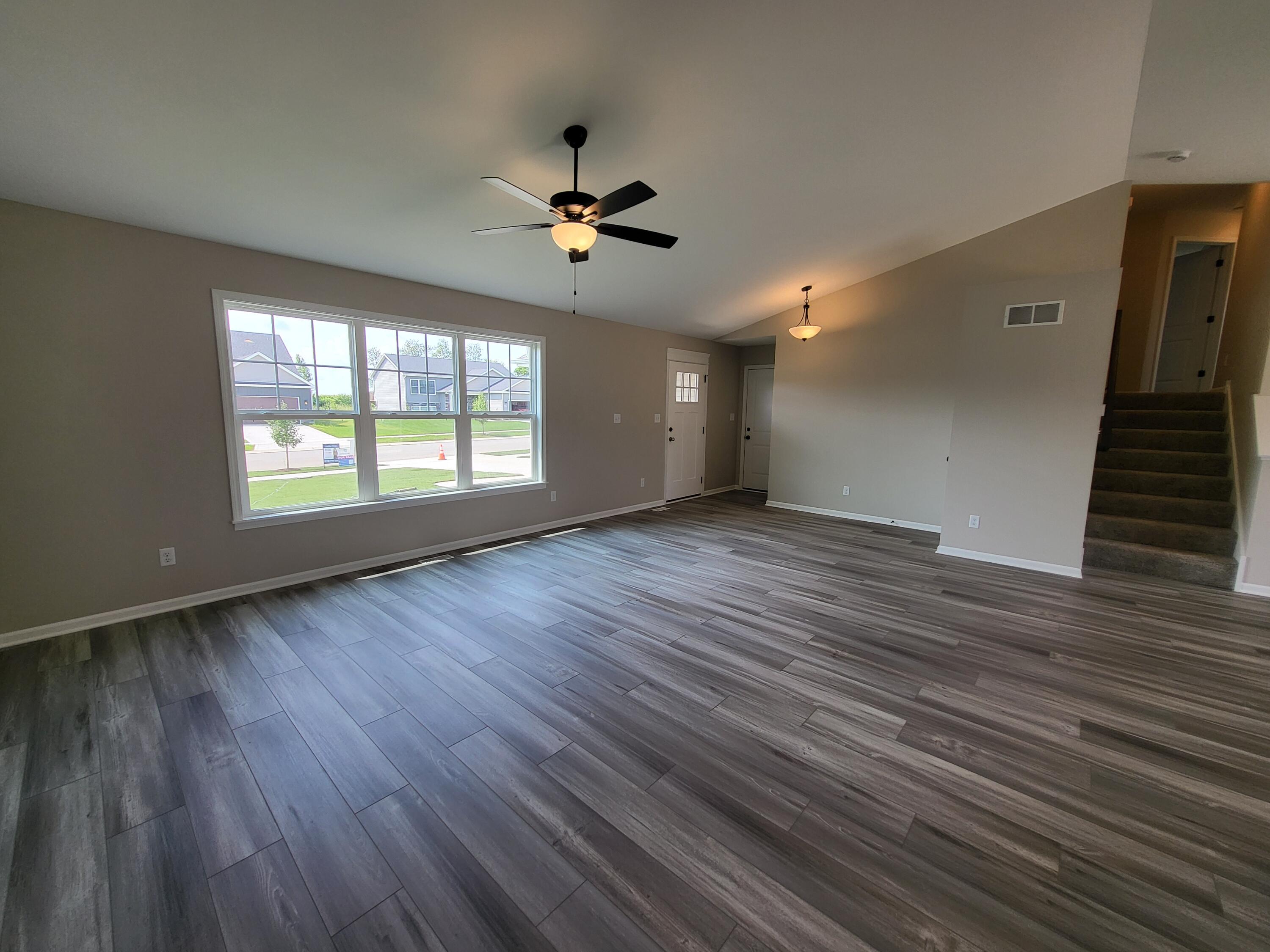 18425 Alexander Avenue Lowell, IN 46356 - Photo 7 of 34 a view of an empty room with wooden floor and a window