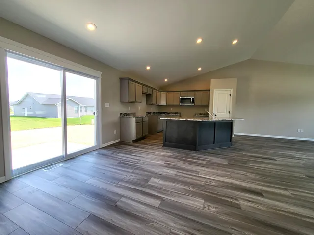 a living room with hard wood floors and furniture or kitchen