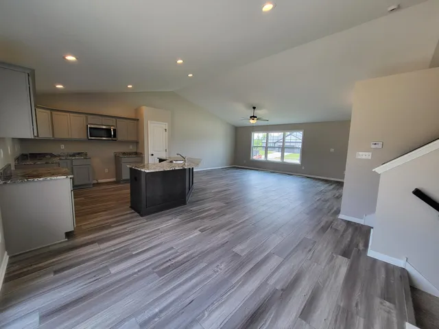 en empty room with ceiling fan and window