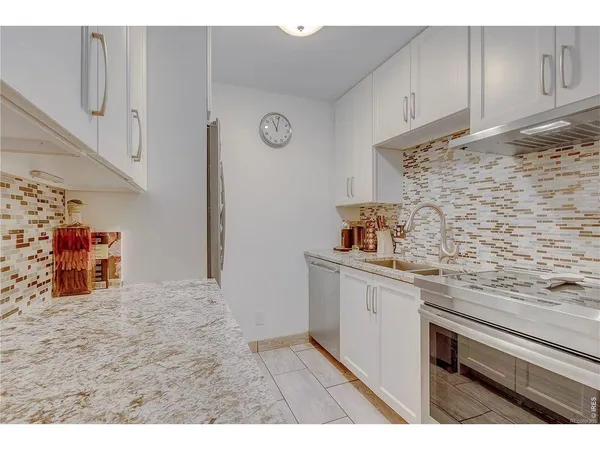 a kitchen with a sink cabinets and a wooden floor