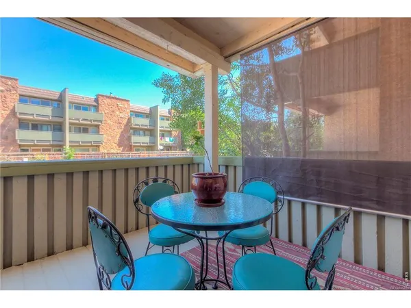 a view of balcony with a table and chairs