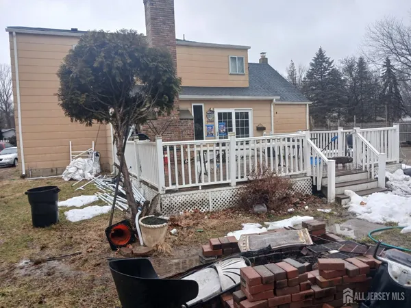 a view of a chairs and table in backyard