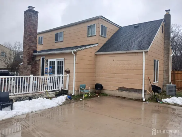a view of a house with wooden fence