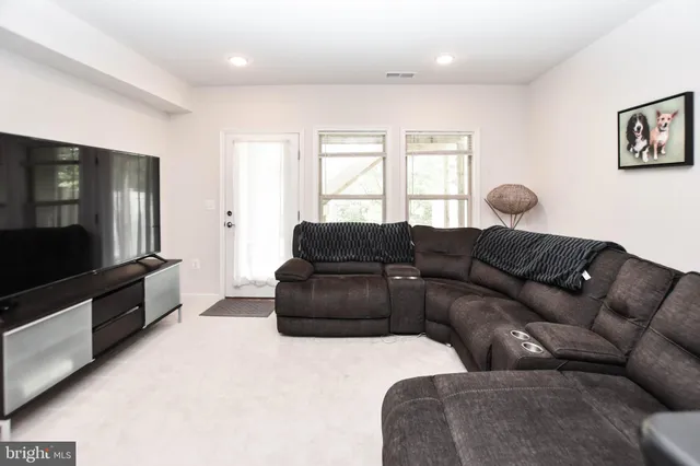 a living room with furniture window and flat screen tv