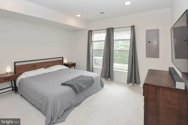 a bedroom with a large bed and a couch