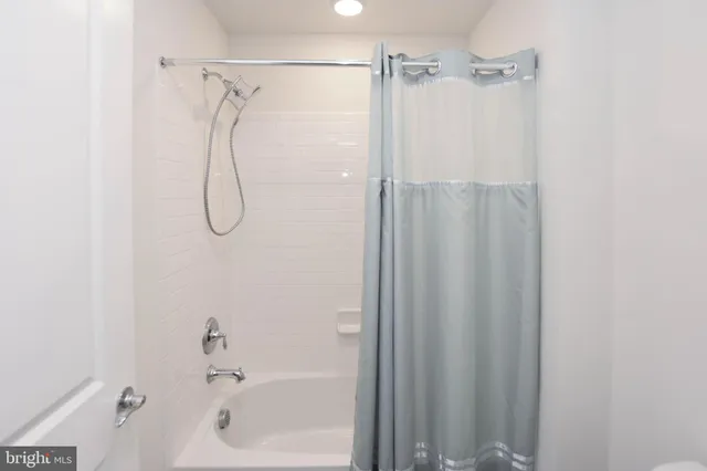 a bathroom with a shower and a shower head