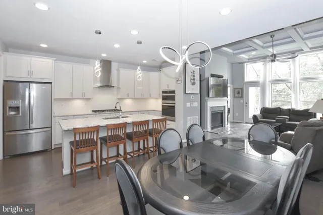 a kitchen with a table chairs stove and refrigerator