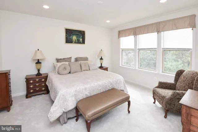 a bedroom with furniture and a large window