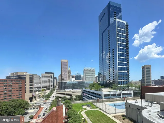 a bedroom with a bed and glass door