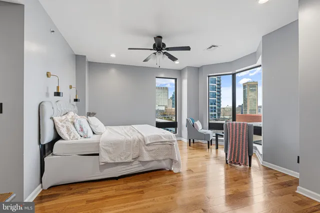 a bedroom with a bed and wooden floor