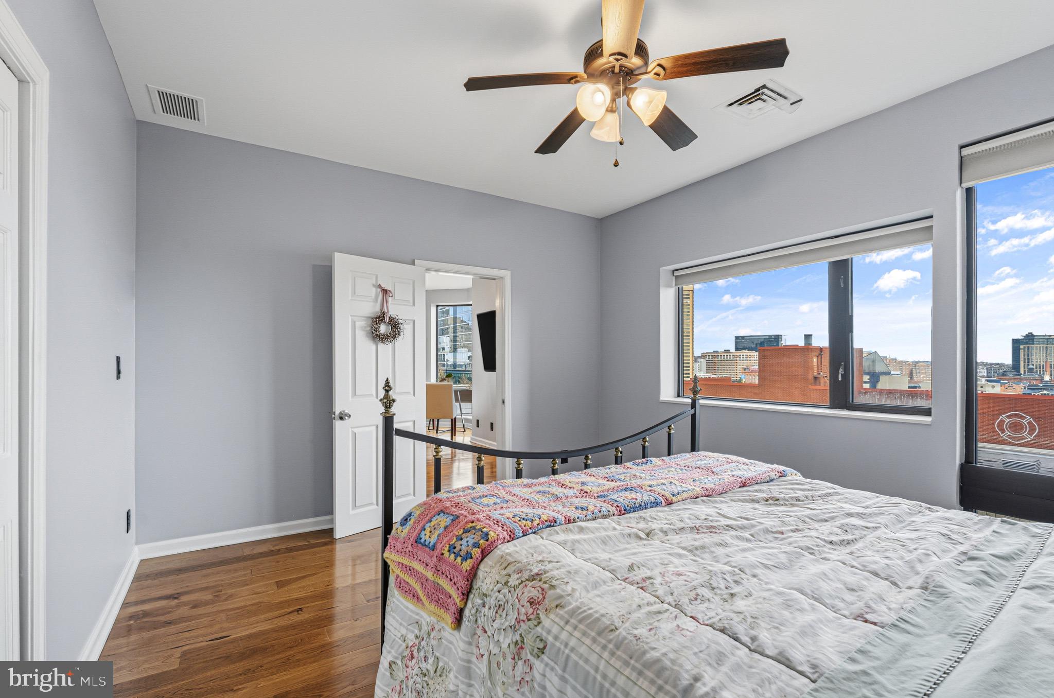 10 East Lee Street, Unit 808 Baltimore, MD 21202 - Photo 26 of 32 a bedroom with a large bed and a window