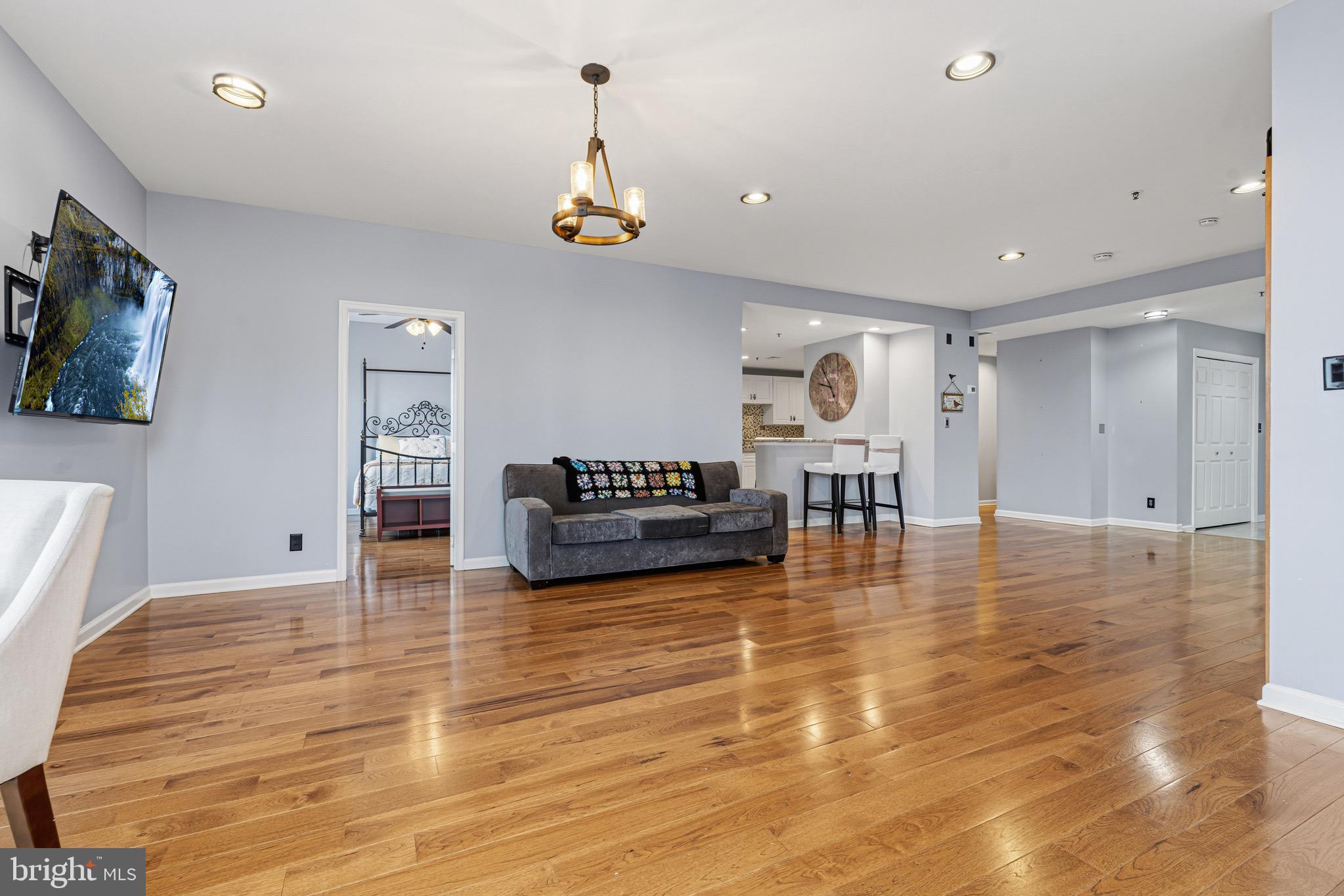 10 East Lee Street, Unit 808 Baltimore, MD 21202 - Photo 5 of 32 a living room with furniture and a wooden floor
