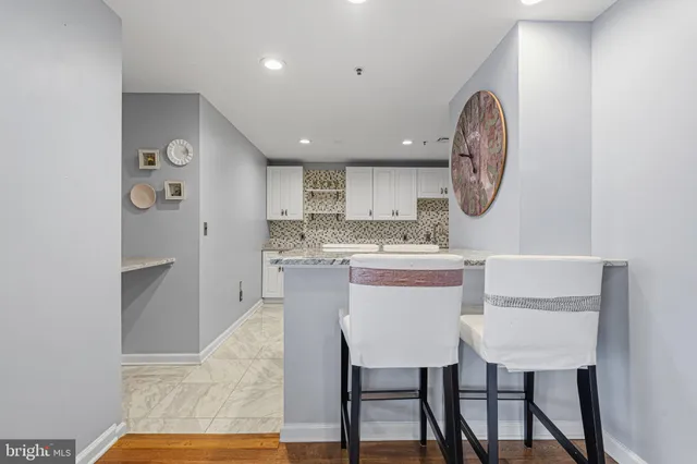 a kitchen with granite countertop a sink stainless steel appliances and cabinets