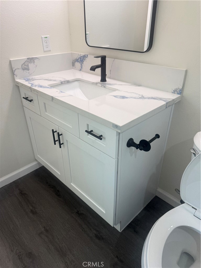 10337 Mull Avenue Riverside, CA 92505 - Photo 19 of 28 a bathroom with a sink toilet and mirror