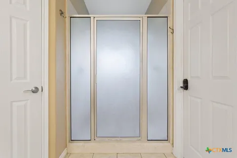 a bathroom with a glass shower door