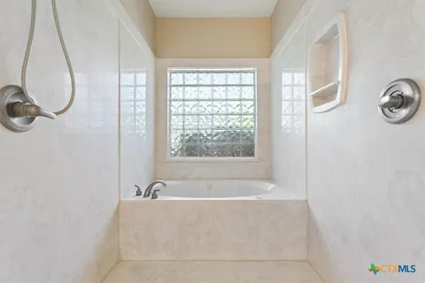 a white bath tub sitting next to a window