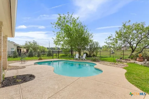 a view of a swimming pool with a patio