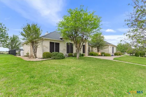 a front view of house with yard and trees