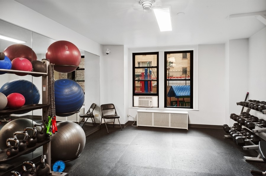 3100 North Sheridan Road, Unit 4B Chicago, IL 60657 - Photo 19 of 19 a room with gym equipment and windows