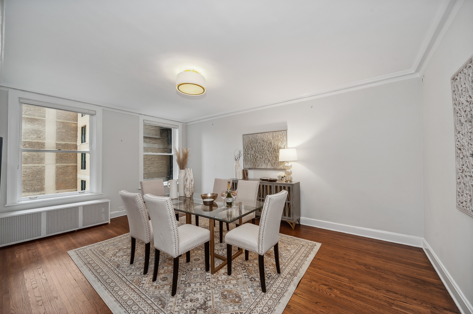 3100 North Sheridan Road, Unit 4B Chicago, IL 60657 - Photo 7 of 19 a dining room with furniture and wooden floor