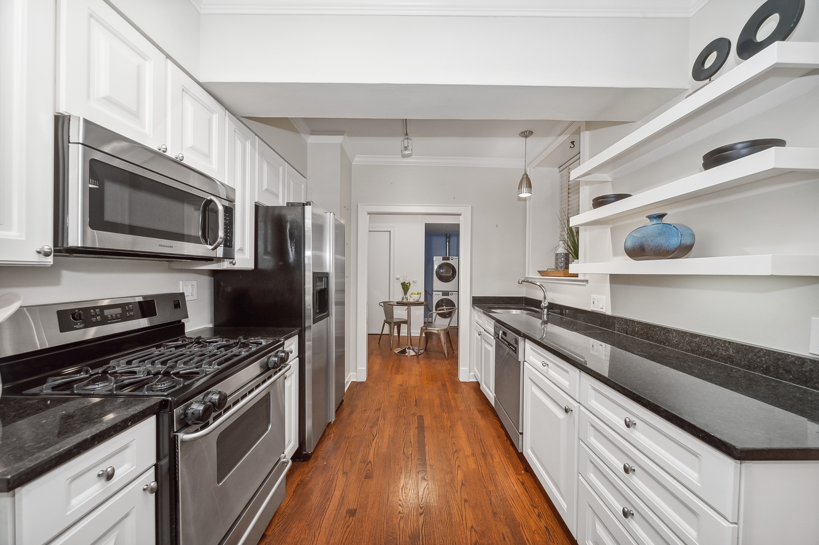 3100 North Sheridan Road, Unit 4B Chicago, IL 60657 - Photo 9 of 19 a large kitchen with stainless steel appliances granite countertop a stove and a sink