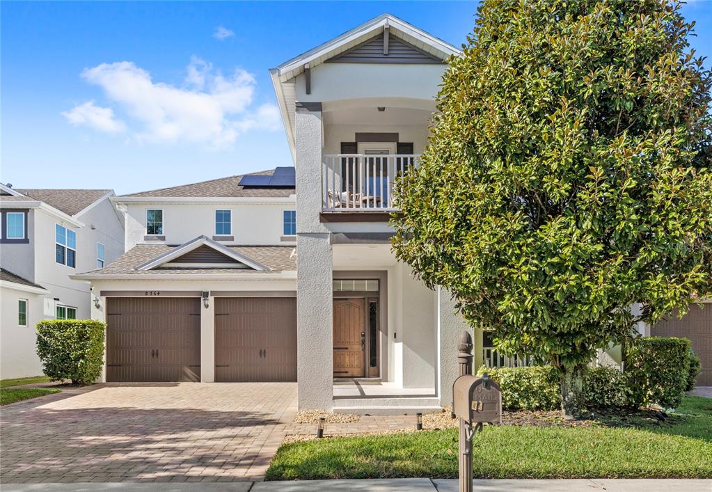 a front view of a house with a garden