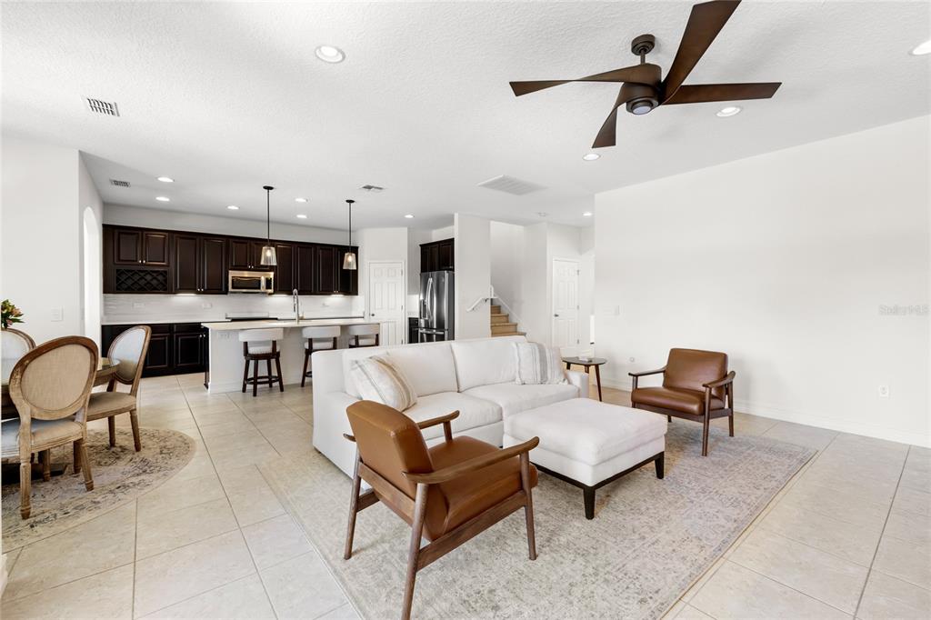 8764 Lookout Pointe Drive Windermere, FL 34786 - Photo 17 of 53 a living room with furniture and a view of kitchen