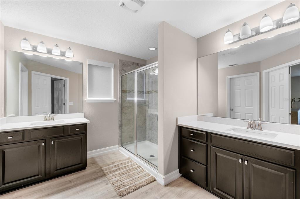 8764 Lookout Pointe Drive Windermere, FL 34786 - Photo 34 of 53 a spacious bathroom with a granite countertop sink mirror and double