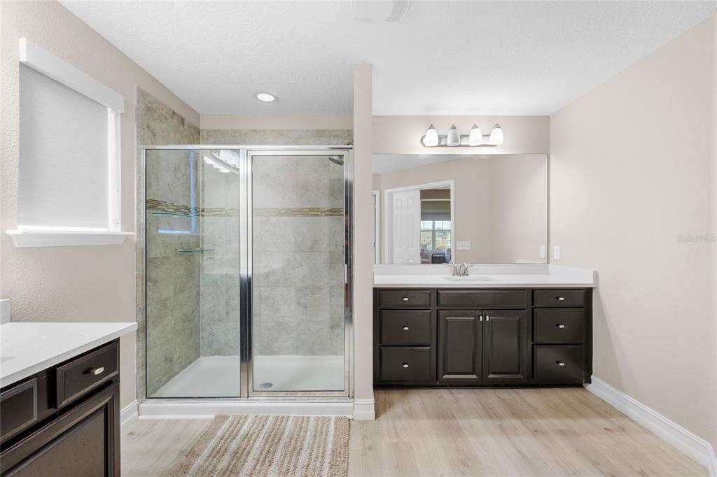 8764 Lookout Pointe Drive Windermere, FL 34786 - Photo 35 of 53 a bathroom with a granite countertop sink a mirror and shower