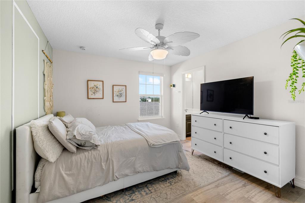 8764 Lookout Pointe Drive Windermere, FL 34786 - Photo 39 of 53 a bedroom with a large bed and a flat screen tv