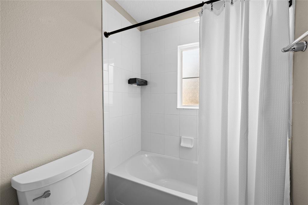 8764 Lookout Pointe Drive Windermere, FL 34786 - Photo 42 of 53 a bath room with a toilet and a bath tub