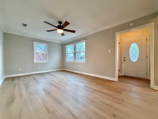 wooden floor in an empty room with a window