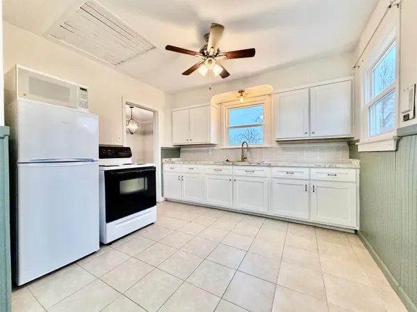 a kitchen with cabinets stainless steel appliances and sink