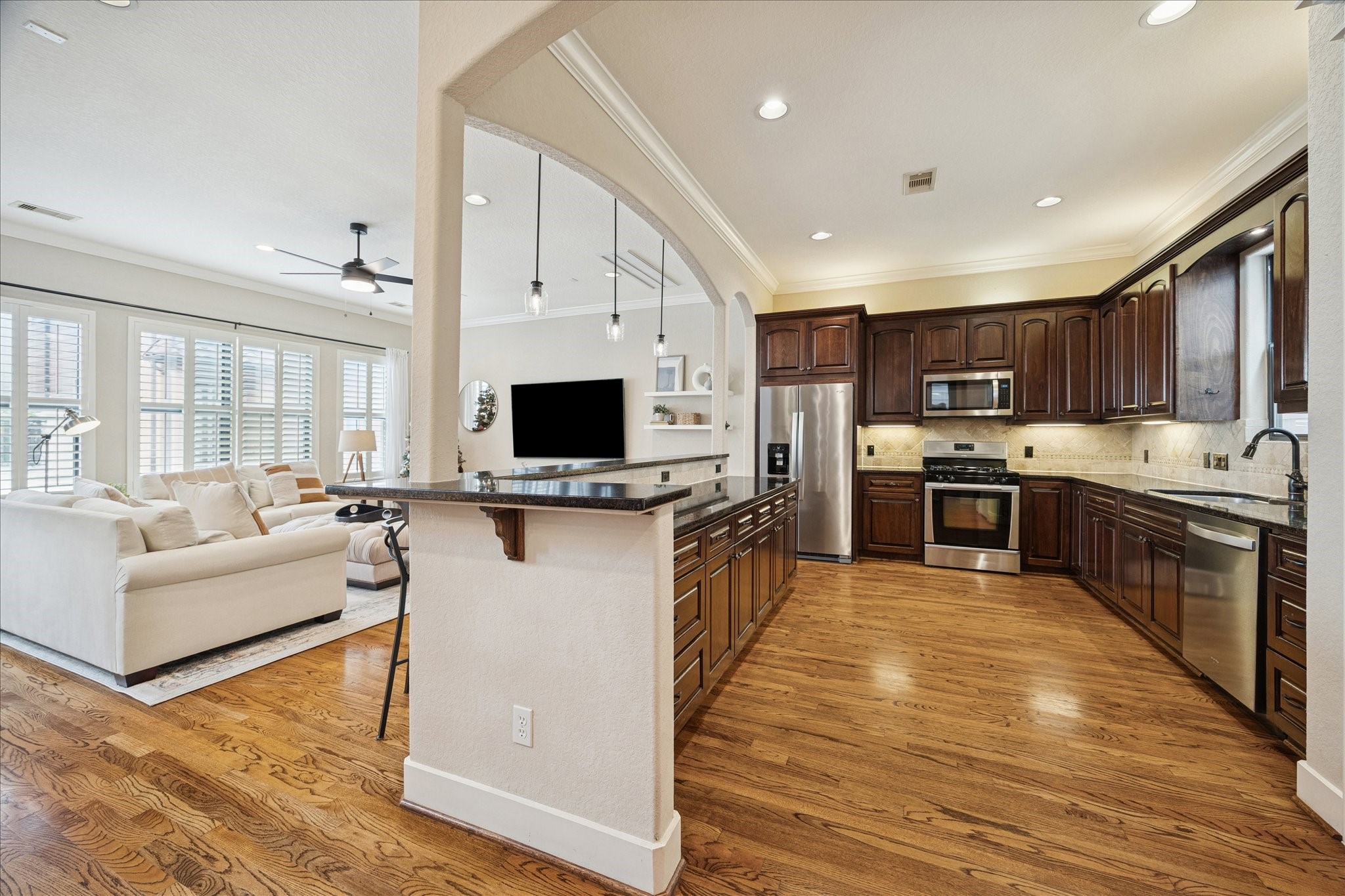 934 West 22nd Street, Unit B Houston, TX 77008 - Photo 4 of 29 a kitchen with stainless steel appliances granite countertop a refrigerator oven a sink dishwasher and white cabinets with wooden floor