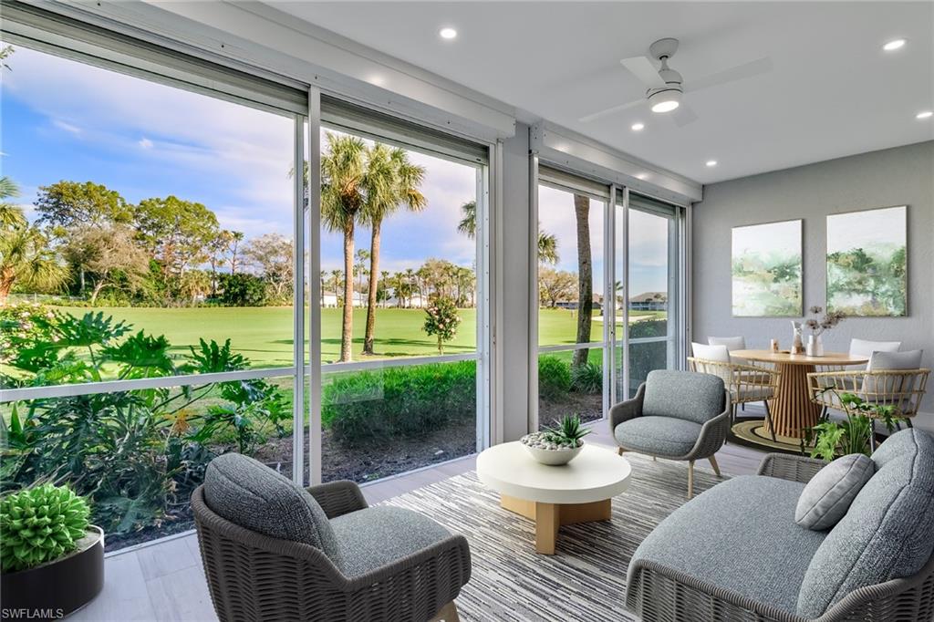 2090 Aberdeen Lane, Unit 101 Naples, FL 34109 - Photo 2 of 37 a living room with furniture and a large window