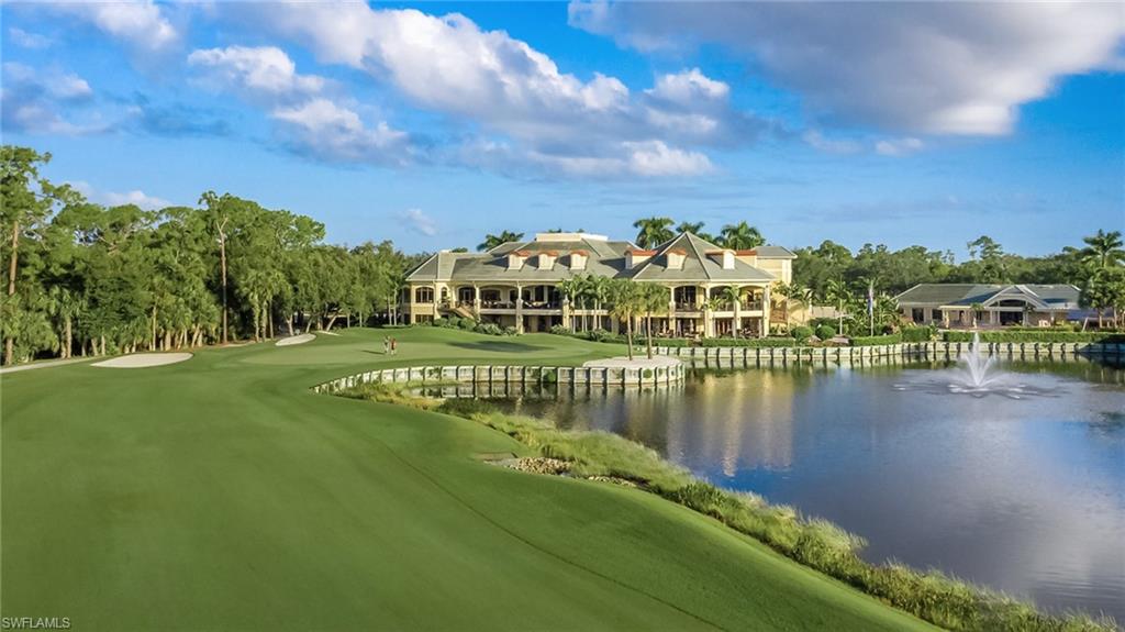 2090 Aberdeen Lane, Unit 101 Naples, FL 34109 - Photo 24 of 37 a view of building with lake and mountain view