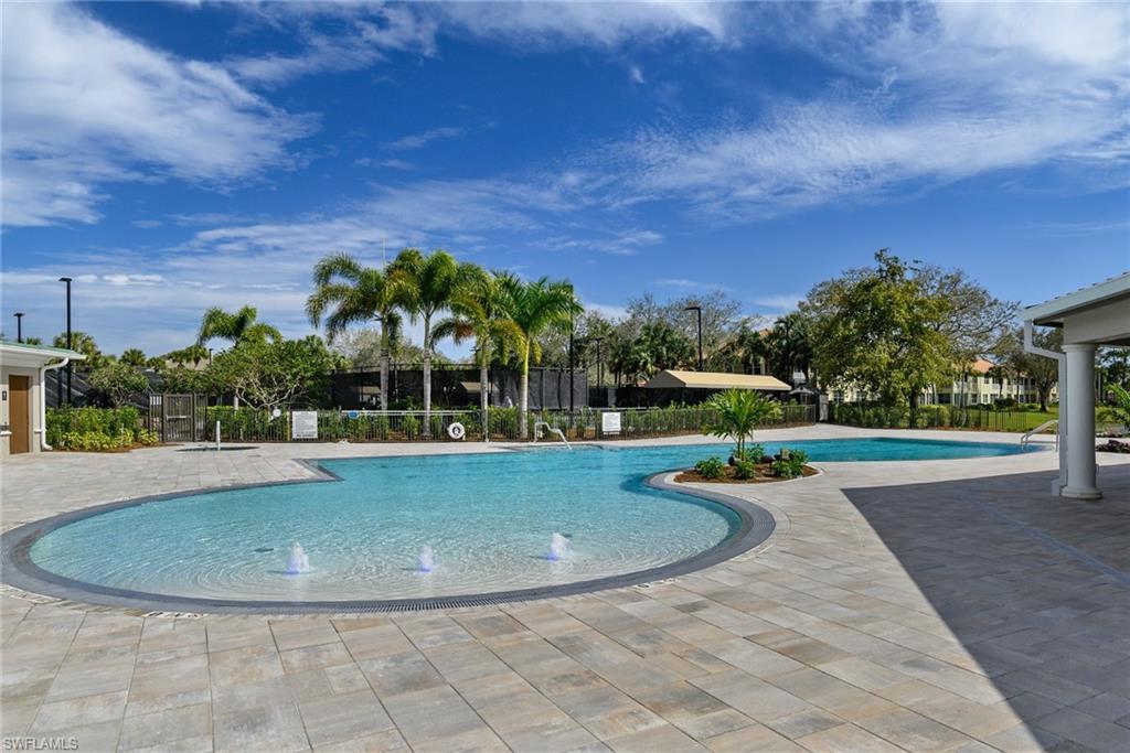 2090 Aberdeen Lane, Unit 101 Naples, FL 34109 - Photo 27 of 37 a view of a swimming pool with a yard