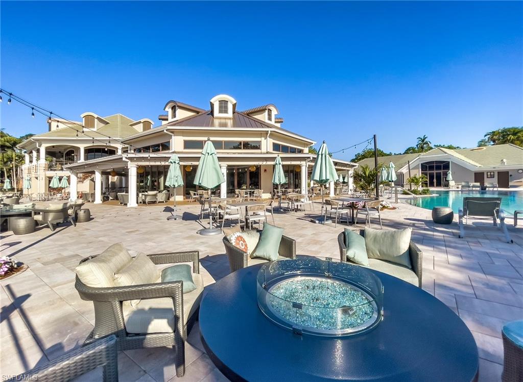 2090 Aberdeen Lane, Unit 101 Naples, FL 34109 - Photo 28 of 37 a view of a swimming pool with outdoor seating