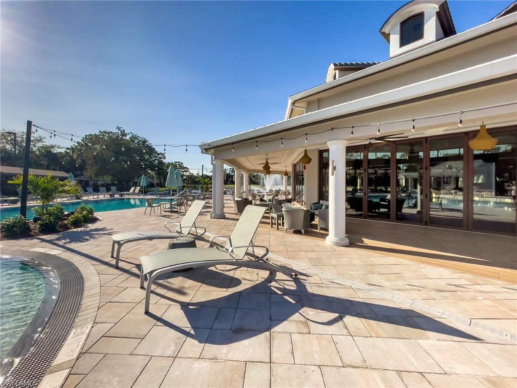 2090 Aberdeen Lane, Unit 101 Naples, FL 34109 - Photo 29 of 37 a living room with patio furniture and a patio