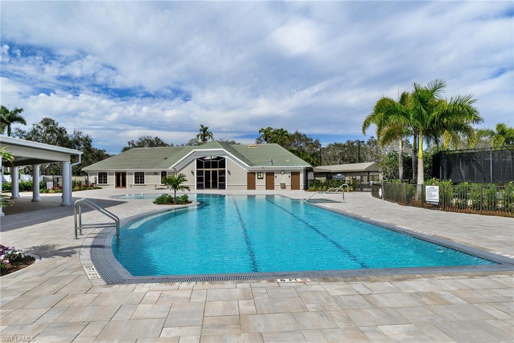 2090 Aberdeen Lane, Unit 101 Naples, FL 34109 - Photo 33 of 37 a front view of a house with garden