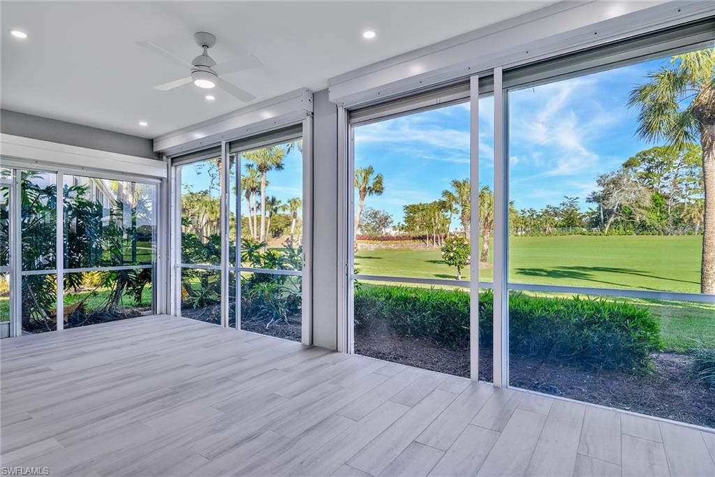 2090 Aberdeen Lane, Unit 101 Naples, FL 34109 - Photo 7 of 37 a view of a porch with wooden floor and garden