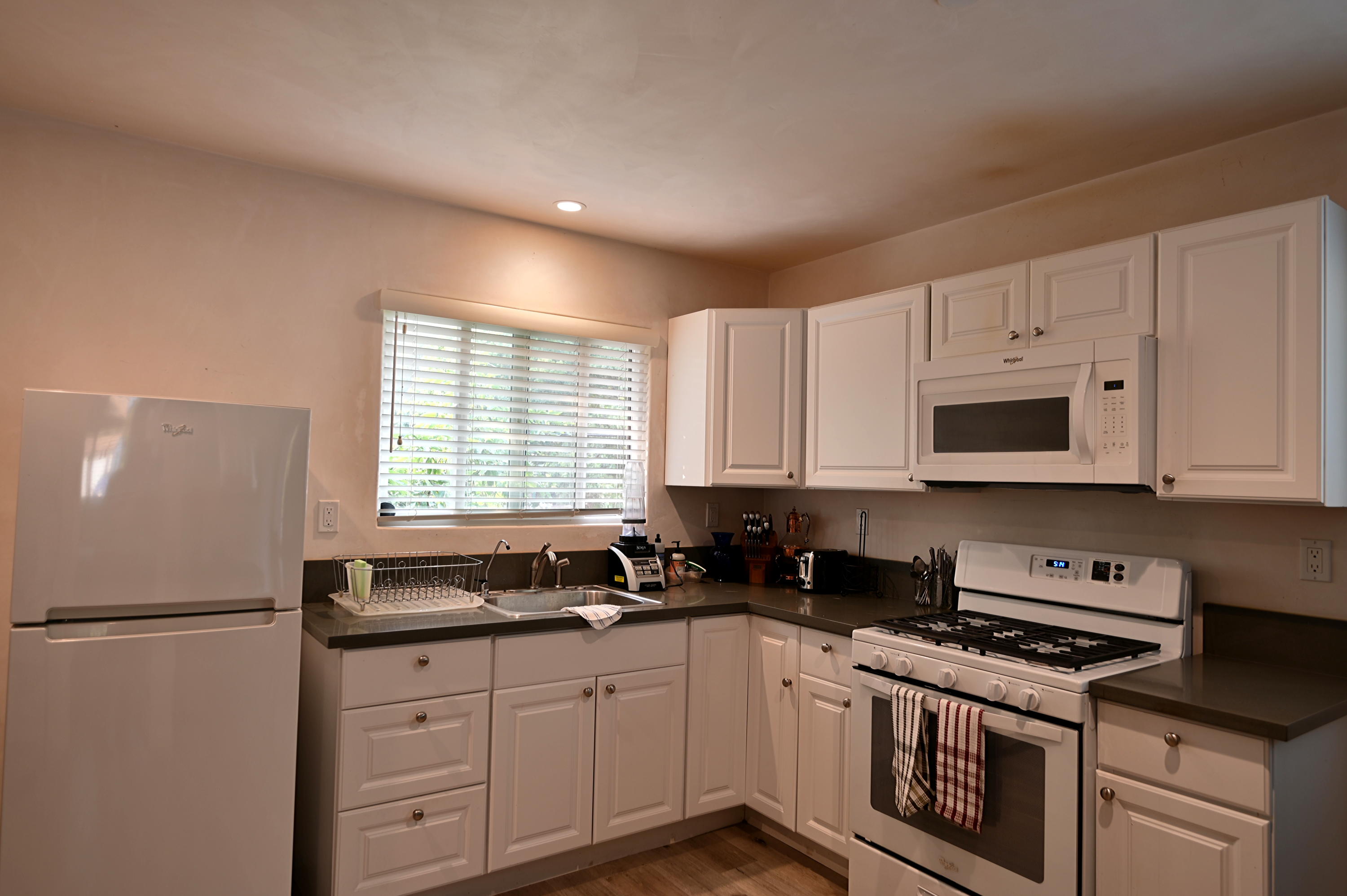 0 Rancho Embarcadero Goleta, CA 93117 - Photo 5 of 7 a kitchen with granite countertop white cabinets and white appliances
