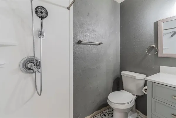 a bathroom with a toilet a shower and a sink
